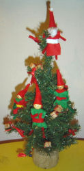 Santa's little helpers add a decorative touch to the Christmas tree!